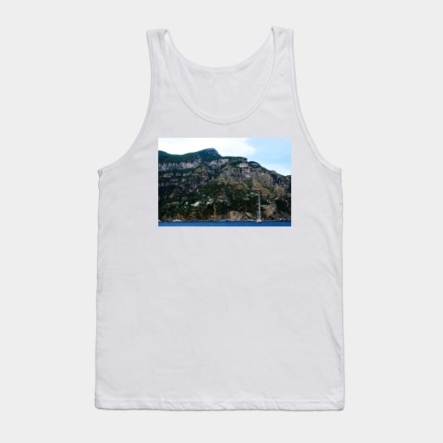 View in Amalfi coast at a huge mountain with rocky parts, greenery and buildings with a white boat underneath Tank Top by KristinaDrozd